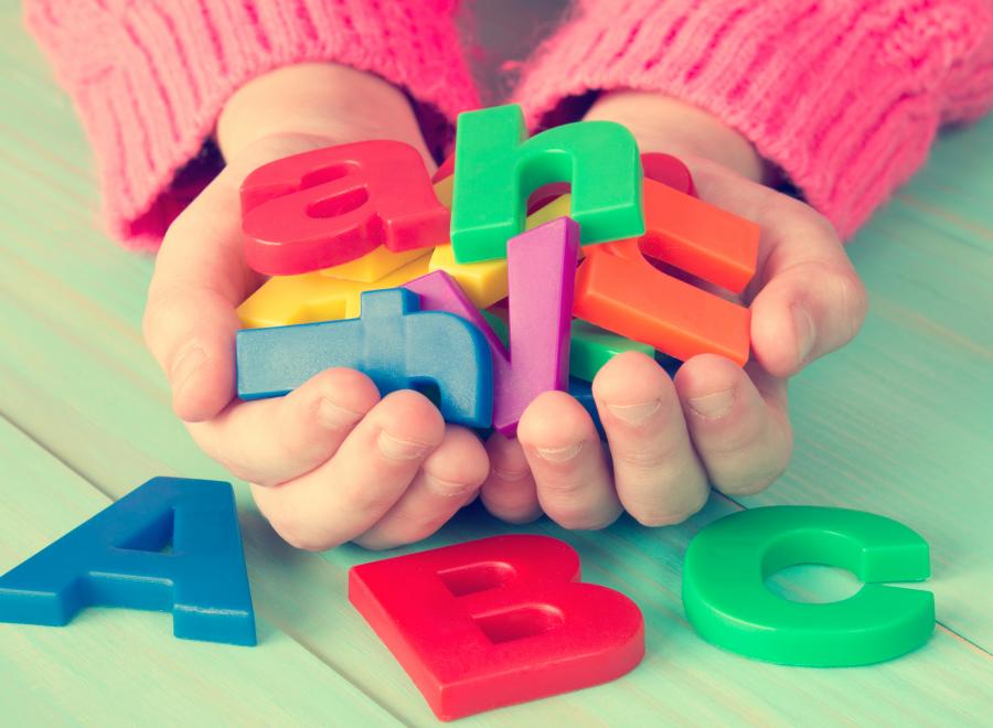 Child holding alphabet blocks