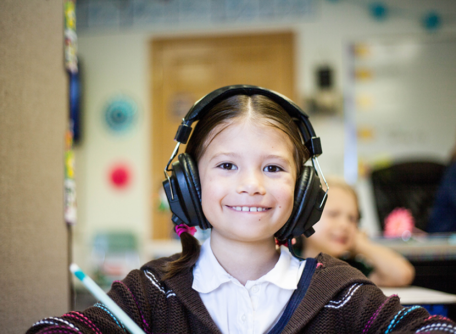 Girl with headphones on during lesson
